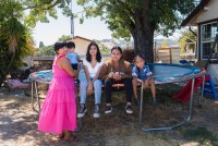 A photo shows the Bravo family together outside their home.