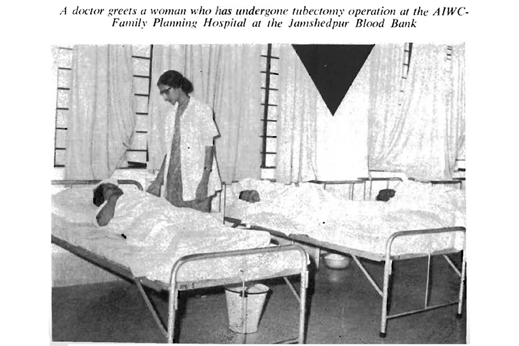 A black-and-white photograph from 1976 shows a female doctor leaning over the bed of a patient recovering from surgery. The image caption reads: 鈥淎 doctor greets a woman who has undergone tubectomy operation at the AIWC-Family Planning Hospital at the Jamshedpur Blood Bank.鈥�