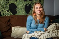 Nina Shand sits on a couch in her home.